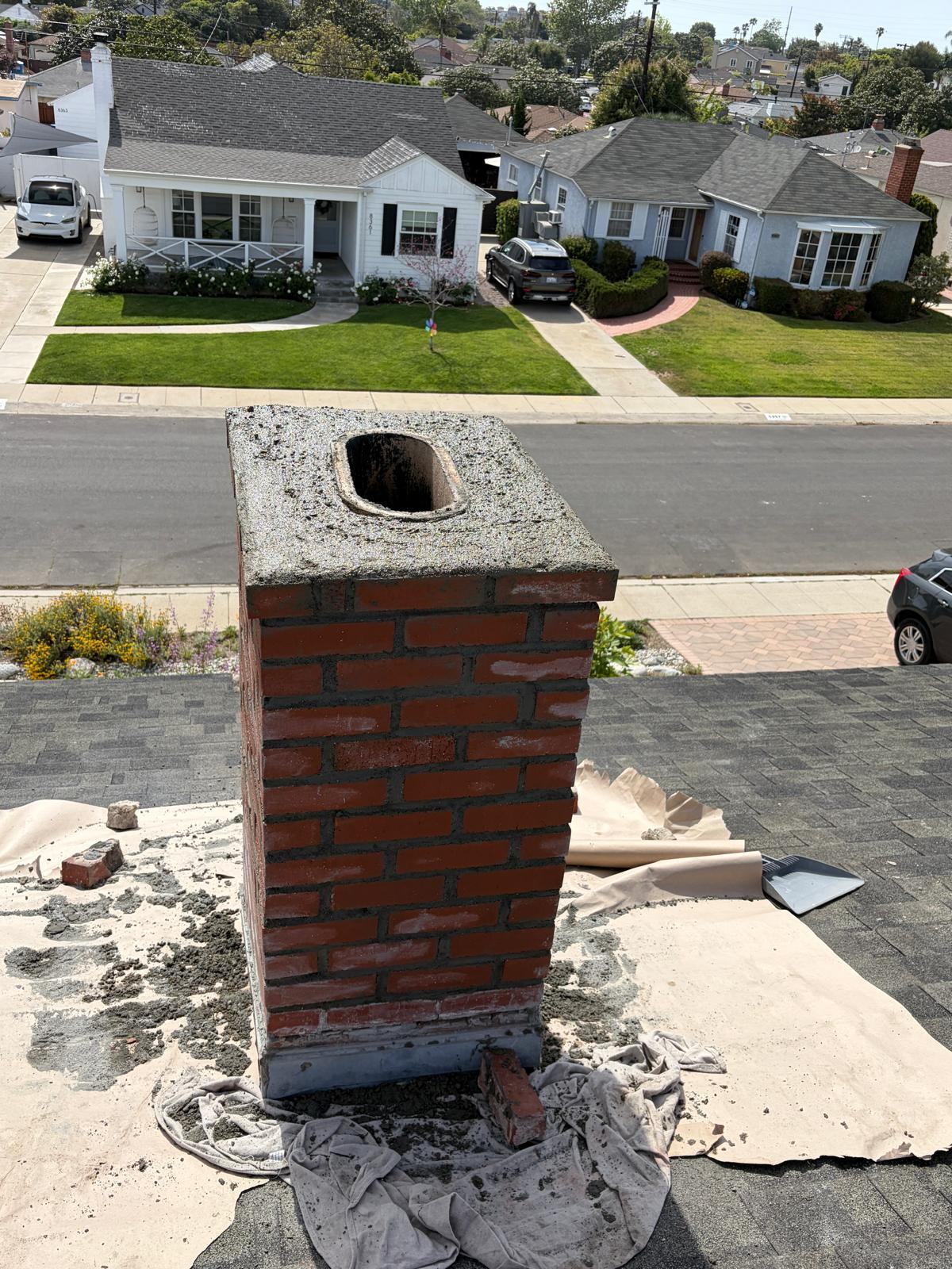 Rebuilt chimney with freshly poured concrete crown